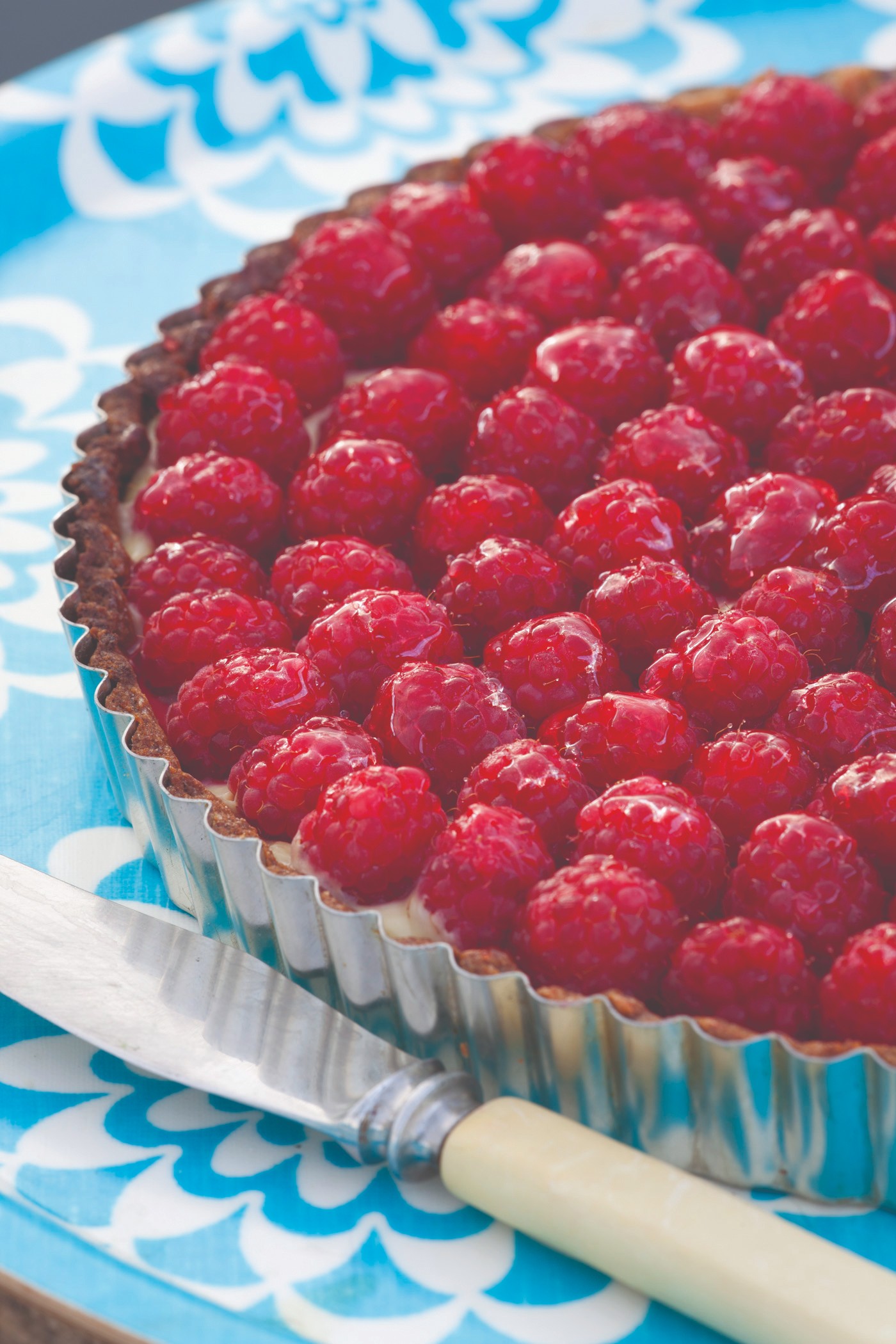 Lemon tart topped with raspberries